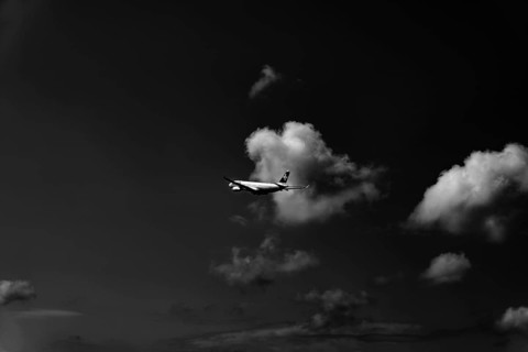 Swiss Airlines Passenger Airplane Flying Against Sky and Clouds in a Sunny Summer Day From the