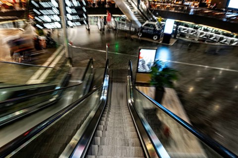 Inside Illuminated Zurich Airport with Escalator in Blurred Motion at Night in the Airport in