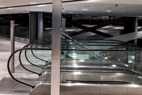 Inside Illuminated Zurich Airport with Escalator at Night in the Airport in Kloten, Zurich, Zurich