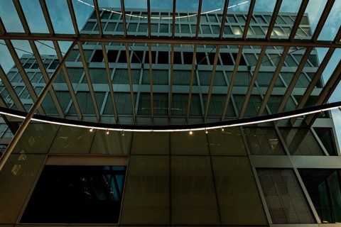 Modern Illuminated Office Building to Zurich Airport at Night in the Airport in Kloten, Zurich,