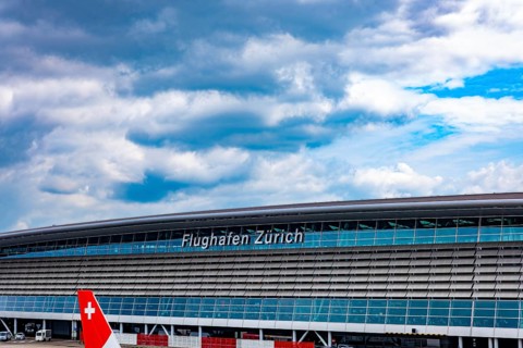 Zurich Airport and Building on Airfield in a Sunny Summer Day with Blue Sky and Clouds From the