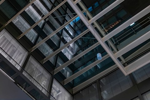 Modern Illuminated Office Building to Zurich Airport at Night in the Airport in Kloten, Zurich,