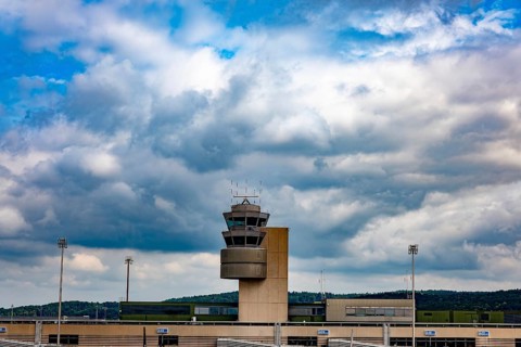 Air Traffic Control Tower on the Airfield in a Sunny Summer Day with Blue Sky and Clouds From the