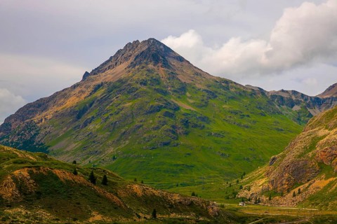 House and a Mountain Peak in the Swiss Alps in a Sunny Summer Day in Diavolezza, Corvatsch,