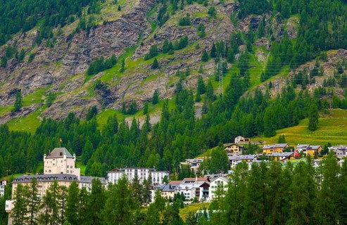 Luxury Hotel in the Forest with Mountain View in the Swiss Alps in a Sunny Summer Day in