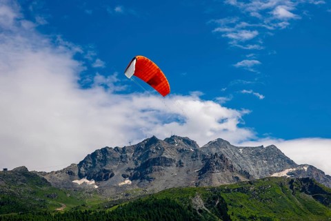 Kitesail and Mountain Peak in the Swiss Alps on Alpine Lake Silvaplana in a Sunny Summer Day in