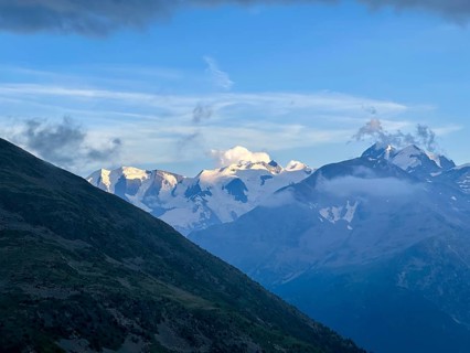 Beautiful Aerial View over the Swiss Alps with Glacier in a Sunny Summer Day and Sky with Clouds