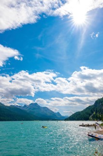 Windsurfing and Wingsurfing on Alpine Lake Silvaplana in a Sunny Summer Day with Mountain View in