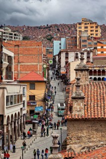 Lively city scene with tiled roofs and people on a street promenade, people in the streets of La