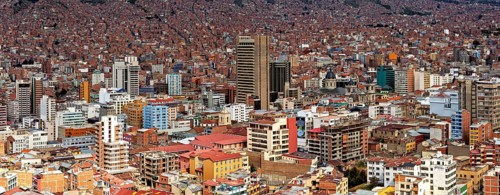Dense urban development of La Paz with many buildings under a clear sky, The houses and skyscrapers