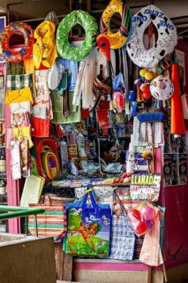 Colourful stall full of toys and colourful objects at a lively market, Small shops and restaurants