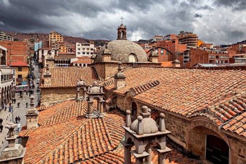 Urban view with church and historical buildings under a cloudy sky, The Cathedral of San Fransisco