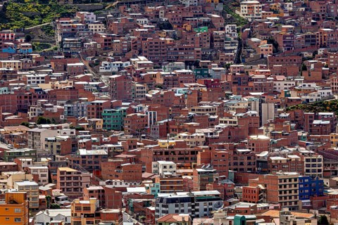 Dense cluster of houses on hills in an urban environment, The houses and skyscrapers of the city