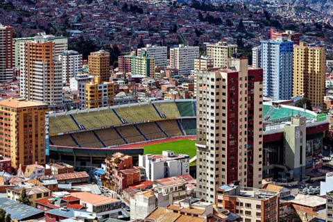 Cityscape with a large stadium surrounded by skyscrapers, The houses and skyscrapers of the city