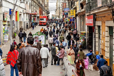 Busy street in a city with many people and shops in La Paz, people in the city centre of La Paz in