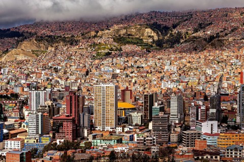 Dense cluster of houses of La Paz embedded in a hilly landscape, The houses and skyscrapers of the