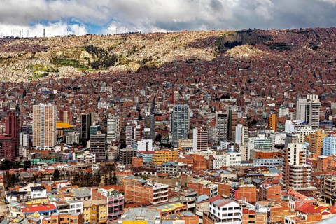 Dense development of a city with many high-rise buildings and clouds, The houses and skyscrapers of