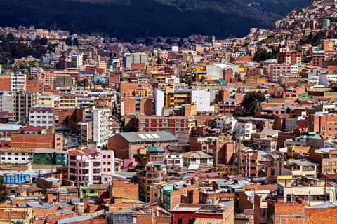 Dense urban development in front of a mountain landscape, The houses and skyscrapers of the city