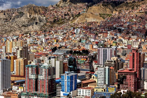Densely built-up urban landscape with mountains in the background, The houses and skyscrapers of