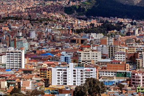 Urban panorama with surrounding mountains and numerous buildings, The houses and skyscrapers of the