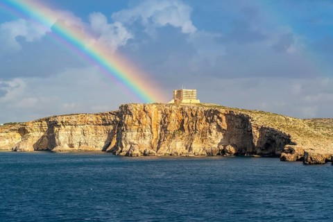Amazing view of rainbow after the rain above Comino island, Malta