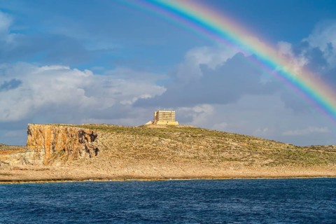 Amazing view of rainbow after the rain above Comino island, Malta