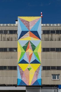 Geometric mural in bright colours on industrial façade, at the port of Linz Upper Austria Austria