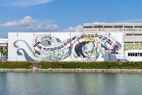 Large-scale dynamic graffiti depiction of a winding train, at the harbour in Linz, Upper Austria