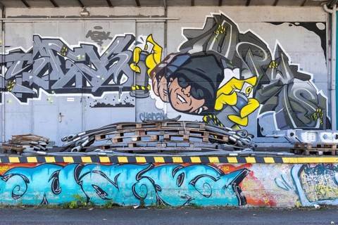 Humorous graffiti with a man and colourful lettering, at the port of Linz Upper Austria Austria