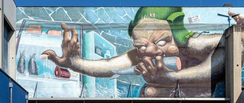 Caricature of a monster searching a fridge, as graffiti, at the harbour of Linz Upper Austria