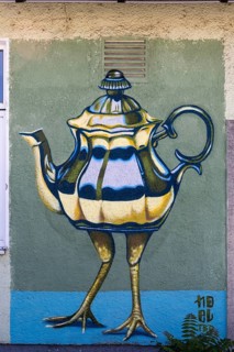 Surreal depiction of a teapot with legs, as a coloured mural, at the port of Linz Upper Austria