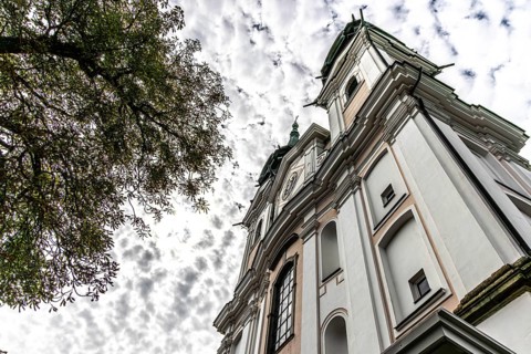 Impressive view of a baroque church from below with silhouette of trees, Pöstlingsbergkirche
