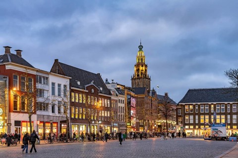 Shops at the fish market Vismarkt and the church tower Martinitoren or Martinitower of the