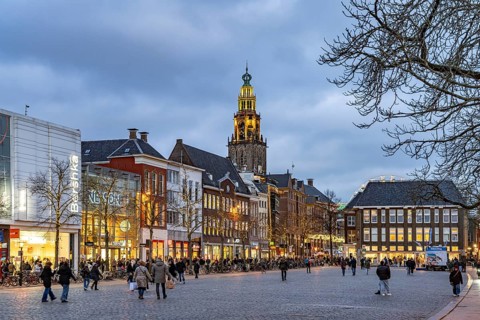 Shops at the fish market Vismarkt and the church tower Martinitoren or Martinitower of the