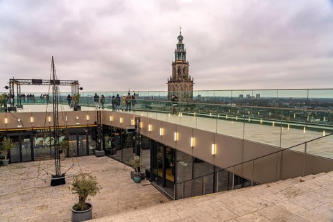 Roof terrace of the Forum Groningen and the Martinitoren church tower of the Martinikerk or Martini