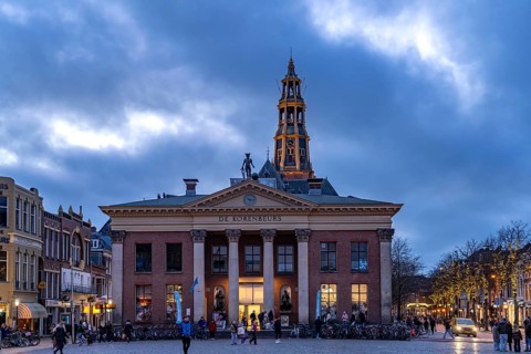 The Vismarkt fish market with the Korenbeurs former grain exchange and the steeple of the Aa church