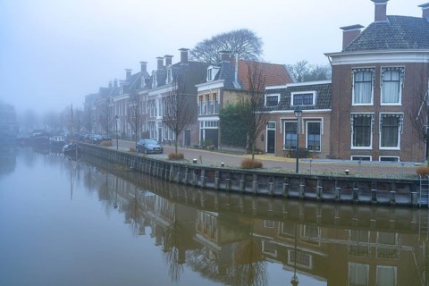 Typical canal in the winter fog, Harlingen, Friesland, Netherlands
