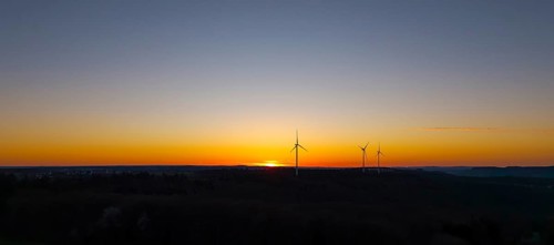 Silhouette of wind turbines at sunset in the distance, near Schorndorf im Remstal,