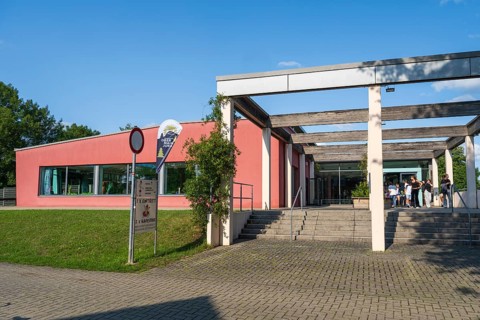 Teenagers in front of the entrance to the indoor swimming pool, Aqua Riese, Bad Staffelstein, Upper
