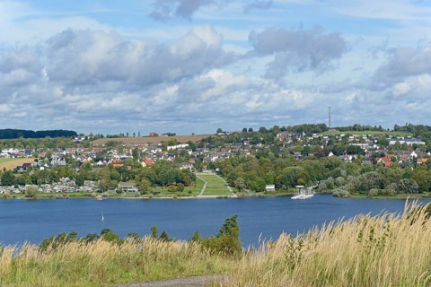 View over the Möhnesee, Körbecke village with the lake park and the lakeside promenade, blue cloudy