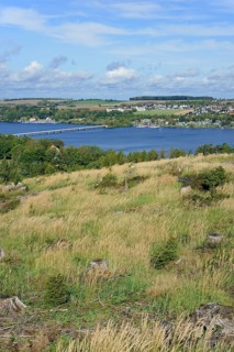 View over the Möhnesee, Körbecke village with the lake park and the lakeside promenade, blue cloudy
