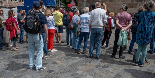Interested tourists listen to a music group in the pedestrian zone, Nuremberg, Middle Franconia,