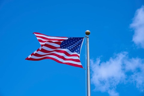 American flag fluttering against a clear blue sky on a sunny day, Flamingo, Everglades National