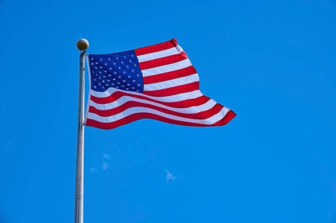 Stars and Stripes waving on a pole under a clear sky, Flamingo, Everglades National Park, Florida,