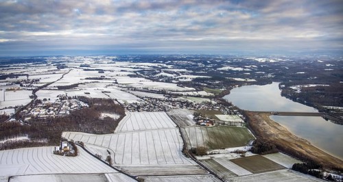 Aerial view of Möhnesee in winter with snow and view of Körbecke in Möhnesee in Sauerland in North