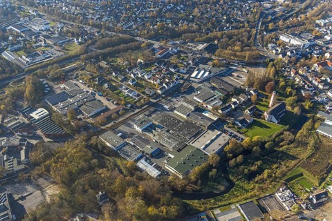 Aerial view, industrial estate Am Törnigskamp and cath. Heilig Kreuz Kirche in Menden, Sauerland,