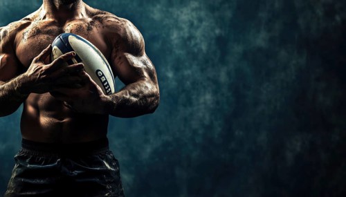 Rugby Player Holding Ball In Horizontal Position, With Space For Text. Action Shot In Sports Of