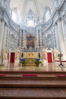 Magnificently decorated church altar in baroque architecture with sculptures and lavish