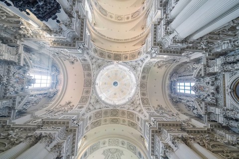 An impressive baroque ceiling with dome and ornamental decorations in a church, Munich, Germany
