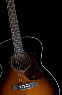 Detail of a acoustic guitar in black back